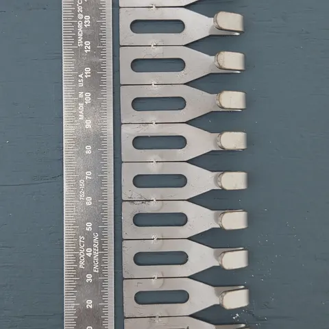 Centre Hook Small (50mm) hooks lined up beside a steel rule
